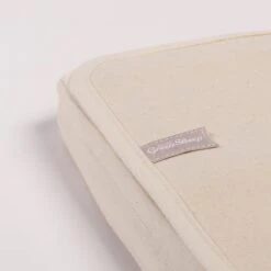 The Little Green Sheep - Organic Crib Mattress Protector 8 The Little Green Sheep - Organic Crib Mattress Protector -Beautiful Bambino Image3 LGS protector OnMattress closeup Crib